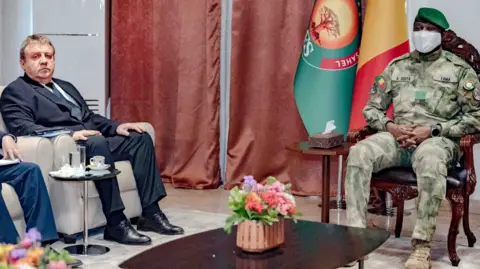 @PresidenceMali Russia's ambassador to Mali, Igor Gromyko, seated on the left in a suit, and Mali's leader Col Assimi Goïta on the right in camouflage. 